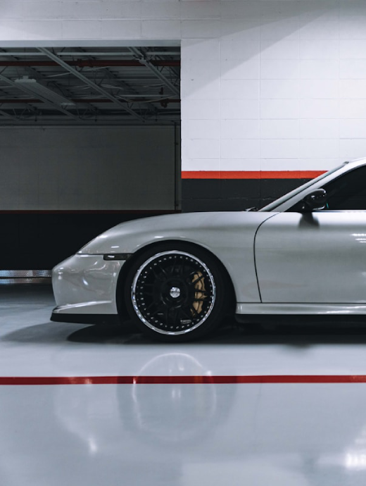 Car parked on a glossy epoxy-coated commercial garage floor