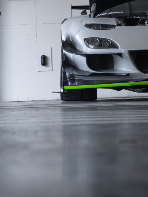 Glossy polished concrete floor with a sports car in a garage