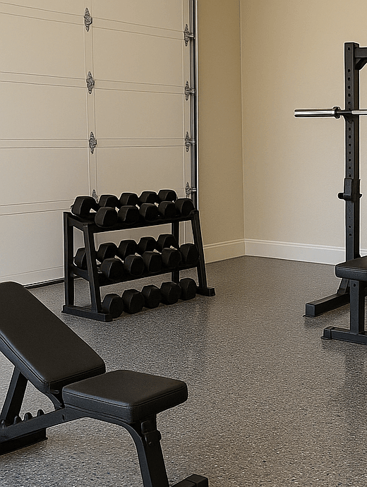 Epoxy flake floor in a home gym with weight bench and dumbbells