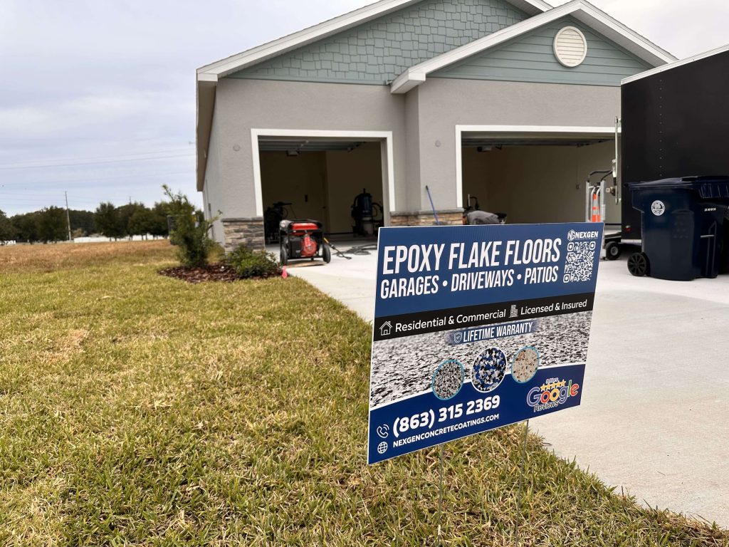 NexGen Concrete Coating lawn sign in front of a garage during epoxy flake floor installation